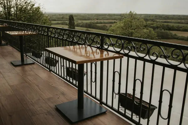 wooden table on the balcony with an iron fence 2025 02 09 09 53 00 utc 1 1